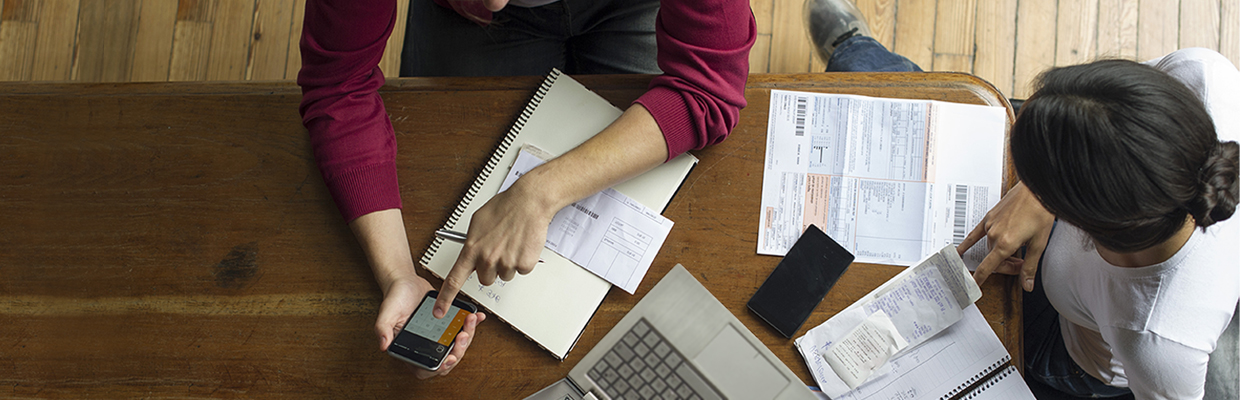 A man is calculating the daily expense with her wife; image used in eStatement/eAdvice page