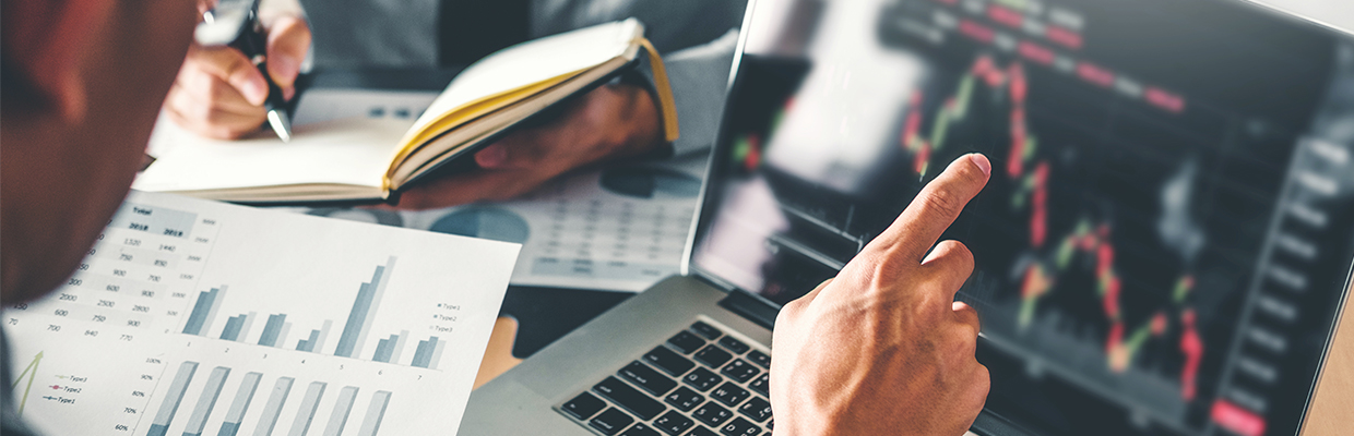 A man reading a stock chart; image used in derivatives / future options product