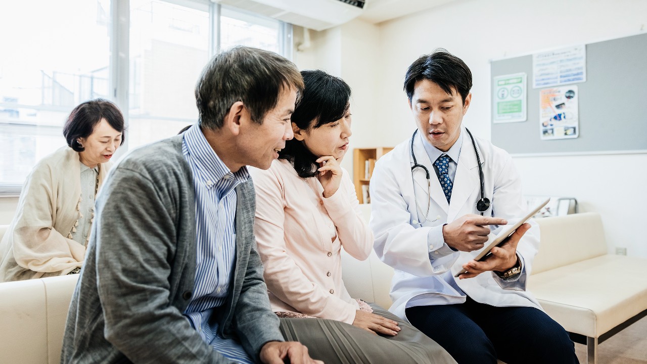 Doctor and couple; image used for HSBC Cancer Care Insurance.